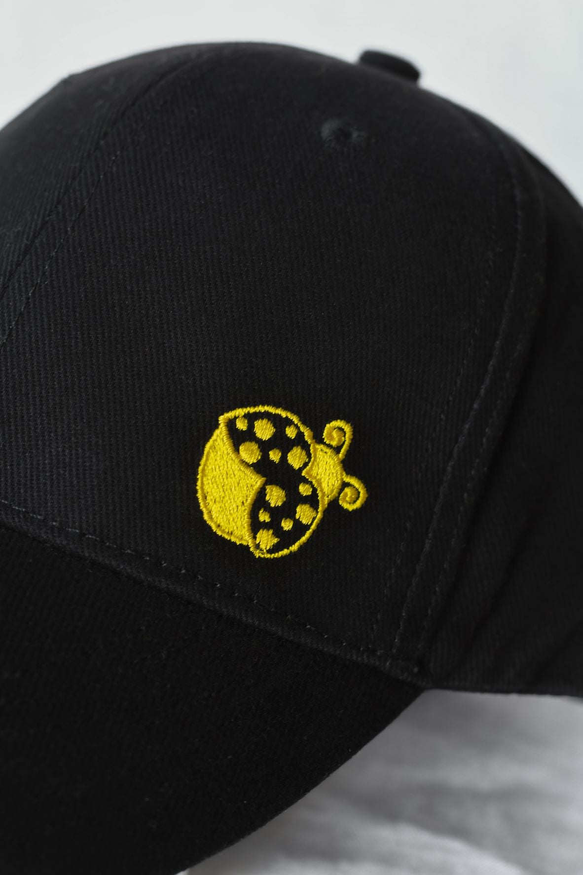 Kids branded Yellow Ladybugs black baseball cap